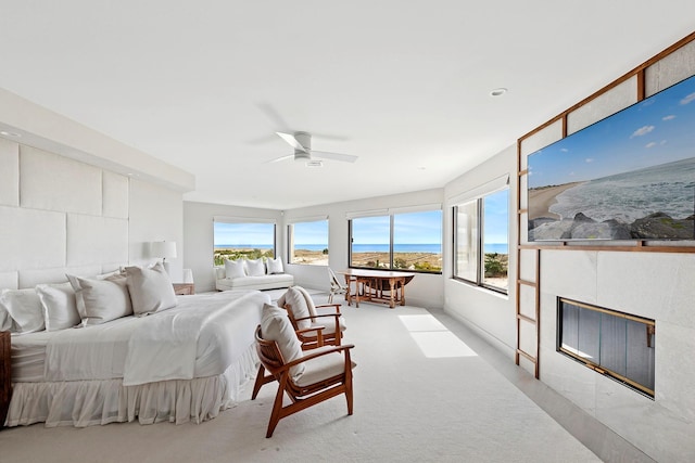 199 Dune Rd, Westhampton Beach, NY 11978 - carpeted bedroom with access to exterior, a fireplace, and a ceiling fan