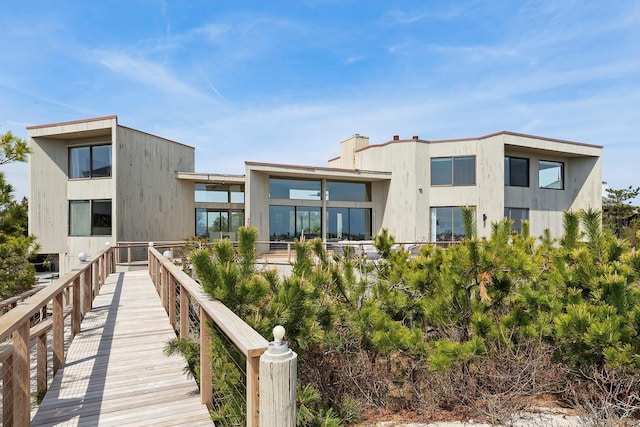 199 Dune Rd, Westhampton Beach, NY 11978 - rear view of property featuring a chimney