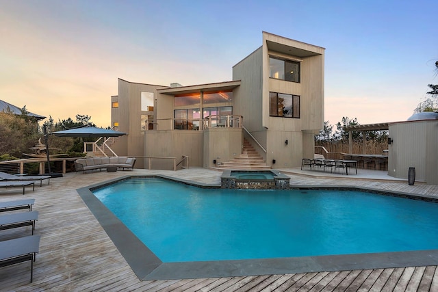 199 Dune Rd, Westhampton Beach, NY 11978 - back of property featuring an outdoor living space, a patio, a pool with connected hot tub, stairs, and a wooden deck