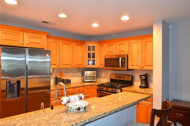 1308 Round Pointe Dr Unit 1308, Haverstraw, NY 10927 - kitchen featuring appliances with stainless steel finishes, tasteful backsplash, light stone counters, glass insert cabinets, and recessed lighting