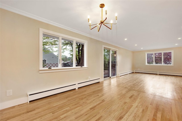 unfurnished room featuring baseboard heating, a chandelier, plenty of natural light, ornamental molding, and wood finished floors