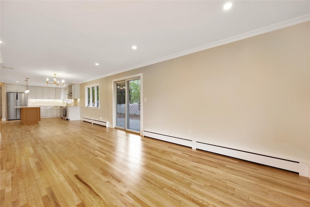 unfurnished living room with baseboard heating, a chandelier, crown molding, light wood finished floors, and recessed lighting