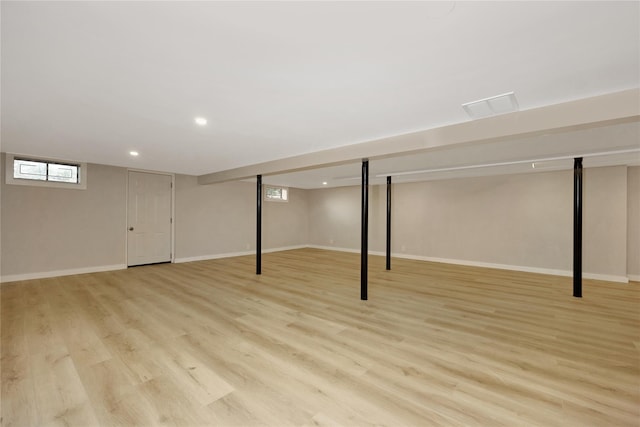below grade area featuring light wood-style flooring, recessed lighting, and baseboards