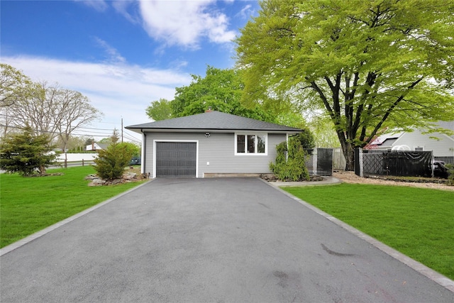 view of front of home featuring asphalt driveway, a chimney, and an attached garage