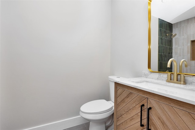 full bath with toilet, vanity, tile patterned flooring, and a tile shower