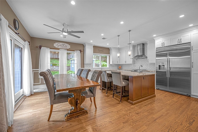 dining room with light wood-style floors, ceiling fan, and recessed lighting