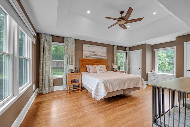 bedroom featuring baseboards, multiple windows, and recessed lighting