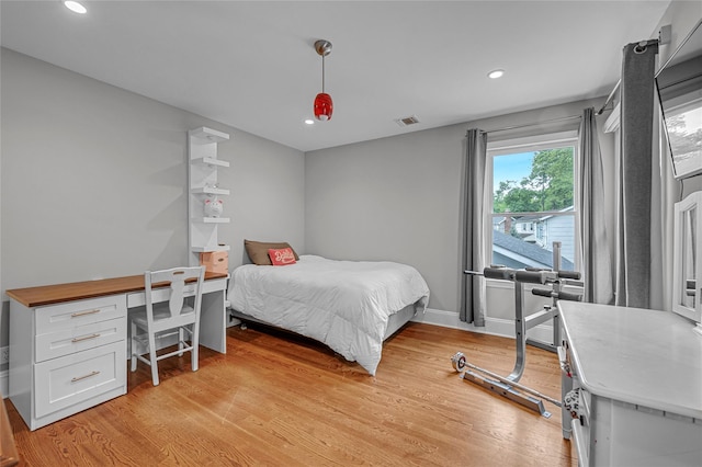 bedroom featuring light wood-type flooring, recessed lighting, and baseboards