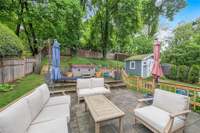 view of patio featuring an outdoor living space, a hot tub, a fenced backyard, an outdoor structure, and a storage shed