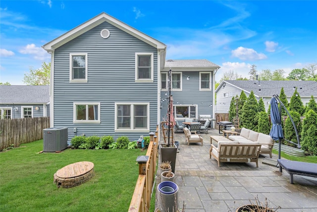 back of house with central AC unit, an outdoor living space with a fire pit, and a patio area