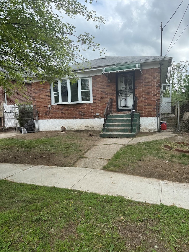 view of front of house with brick siding and fence