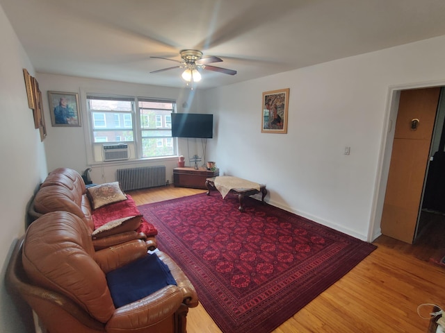 141-24 78th Rd Unit 3A, Kew Garden Hills, NY 11367 - living area with radiator heating unit, ceiling fan, wood finished floors, and cooling unit