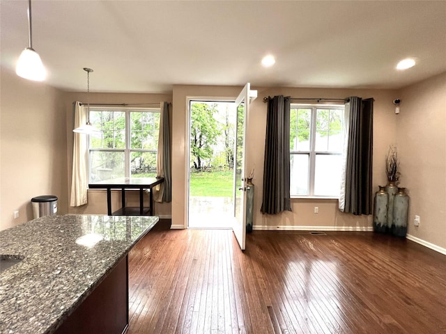 doorway featuring baseboards, dark wood-type flooring, and recessed lighting