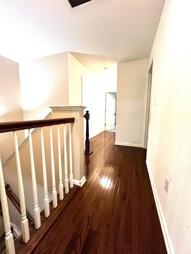 hall with baseboards and dark wood-style flooring