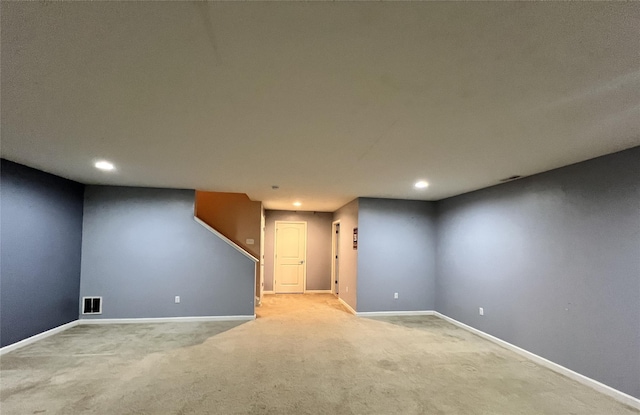 finished below grade area with baseboards, recessed lighting, visible vents, and carpet