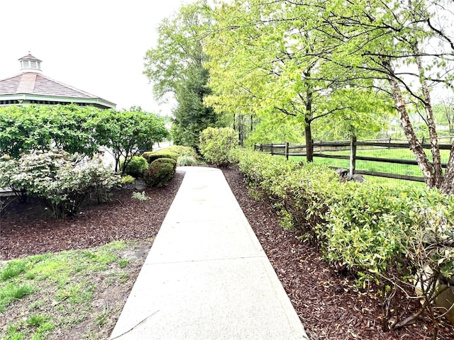 view of home's community featuring fence
