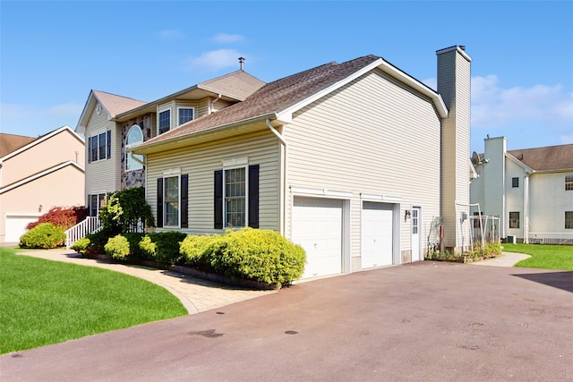 2041 Independence Dr, New Windsor, NY 12553 - view of home's exterior with a garage, a chimney, driveway, and a yard