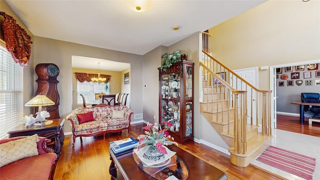 2041 Independence Dr, New Windsor, NY 12553 - living area featuring stairs, hardwood / wood-style floors, a chandelier, and baseboards