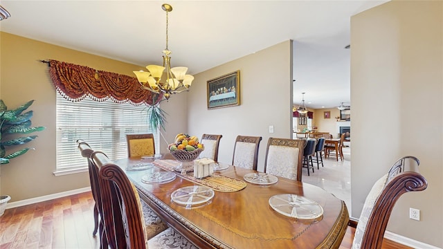 2041 Independence Dr, New Windsor, NY 12553 - dining space with a chandelier, wood finished floors, and baseboards