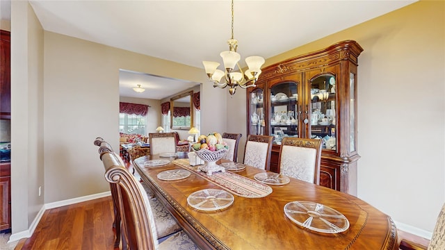 2041 Independence Dr, New Windsor, NY 12553 - dining room with a chandelier, wood finished floors, and baseboards