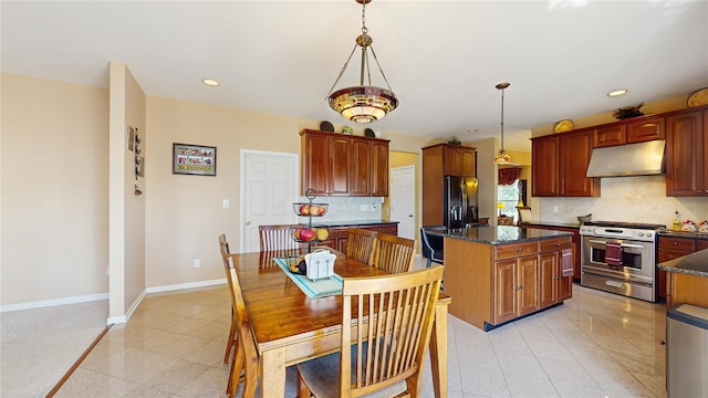 2041 Independence Dr, New Windsor, NY 12553 - kitchen featuring appliances with stainless steel finishes, under cabinet range hood, baseboards, tasteful backsplash, and a center island