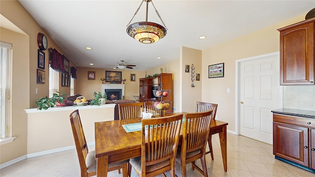 2041 Independence Dr, New Windsor, NY 12553 - dining area featuring a warm lit fireplace, a ceiling fan, recessed lighting, baseboards, and light tile patterned flooring