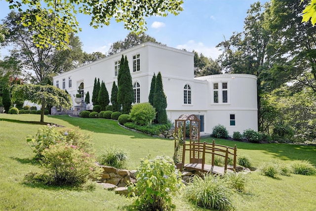65 Round Hill Rd, Armonk, NY 10504 - view of front of property featuring a front yard and stucco siding