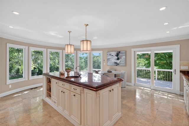 65 Round Hill Rd, Armonk, NY 10504 - kitchen with cream cabinets, crown molding, recessed lighting, a kitchen island with sink, and pendant lighting