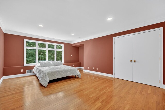 65 Round Hill Rd, Armonk, NY 10504 - bedroom with crown molding, light wood-style flooring, recessed lighting, and a closet