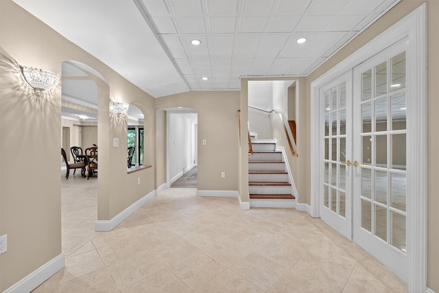 65 Round Hill Rd, Armonk, NY 10504 - entryway with arched walkways, stairs, recessed lighting, light tile patterned floors, and french doors