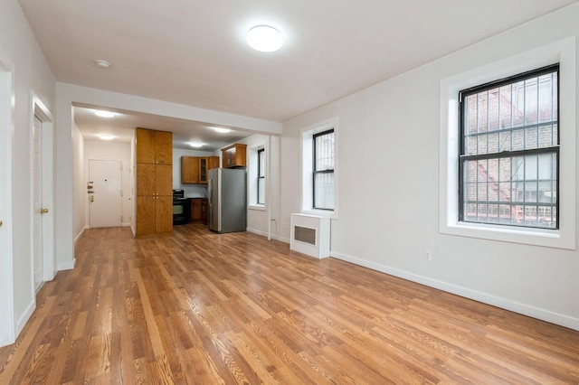62-64 Saunders Unit K2, Rego Park, NY 11374 - unfurnished living room featuring light wood finished floors and baseboards