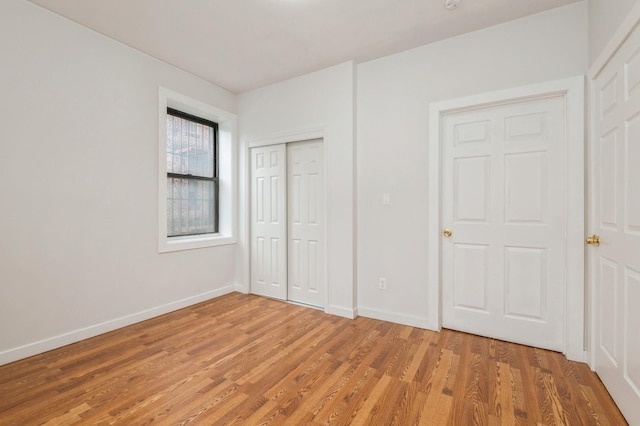 62-64 Saunders Unit K2, Rego Park, NY 11374 - unfurnished bedroom featuring light wood-type flooring, baseboards, and a closet
