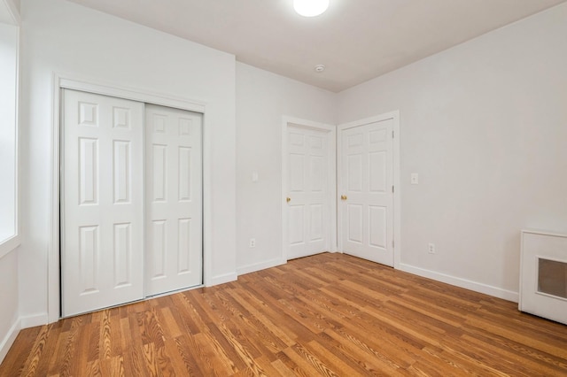 62-64 Saunders Unit K2, Rego Park, NY 11374 - unfurnished bedroom featuring baseboards, light wood-style floors, and a closet