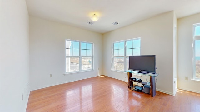 6910 Beach Front Rd, Arverne, NY 11692 - living room with healthy amount of natural light, wood finished floors, and baseboards