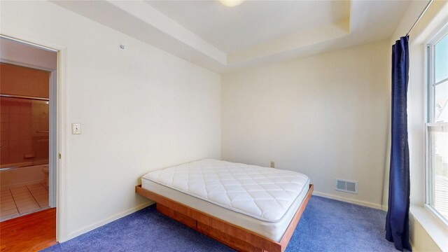 6910 Beach Front Rd, Arverne, NY 11692 - bedroom with multiple windows, baseboards, and a tray ceiling