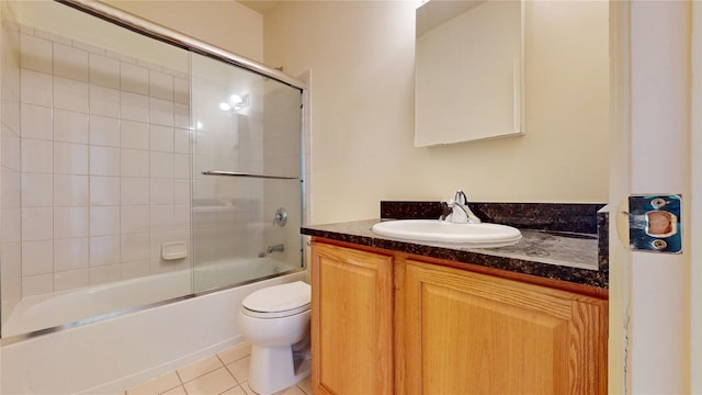 6910 Beach Front Rd, Arverne, NY 11692 - full bathroom with vanity, toilet, tile patterned floors, and bath / shower combo with glass door