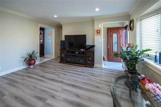 living room with wood finished floors, ornamental molding, and recessed lighting