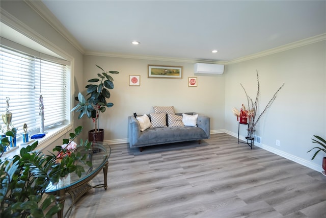 living area with crown molding, wood finished floors, baseboards, and a wall mounted AC