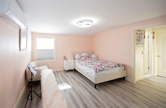 bedroom with light wood finished floors and baseboards