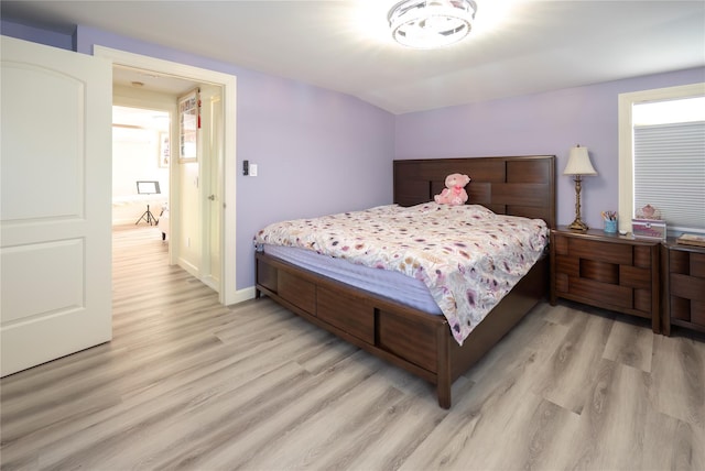 bedroom featuring baseboards and light wood-style flooring