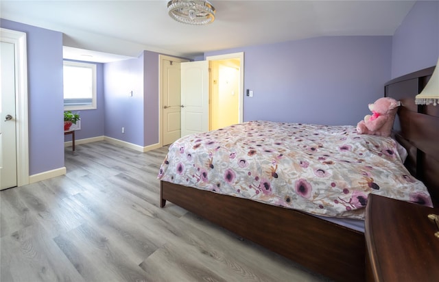 bedroom with light wood-style floors and baseboards