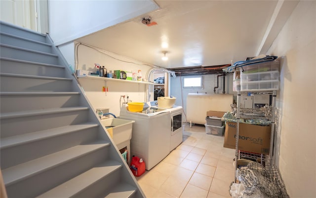 clothes washing area with light tile patterned floors, laundry area, independent washer and dryer, and heating fuel