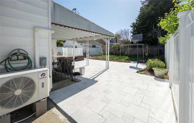 view of patio / terrace featuring an outdoor structure, fence, and ac unit