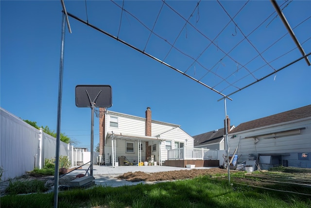 rear view of property with a patio and fence