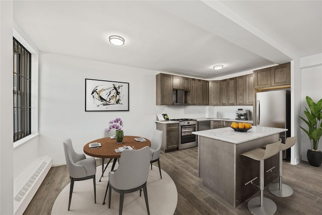 kitchen featuring stainless steel appliances, dark wood-type flooring, dark brown cabinets, and a baseboard heating unit