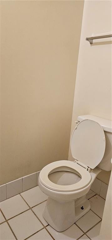 bathroom with toilet and tile patterned floors