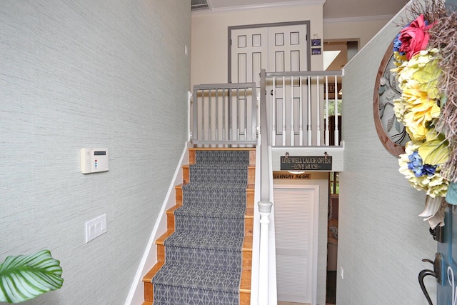 stairs featuring crown molding