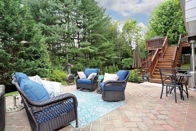 view of patio / terrace with stairs, outdoor lounge area, and a deck