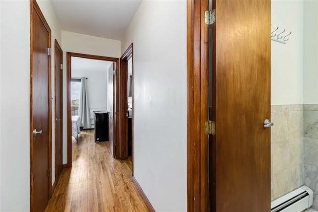 hallway with baseboard heating and light wood-style flooring