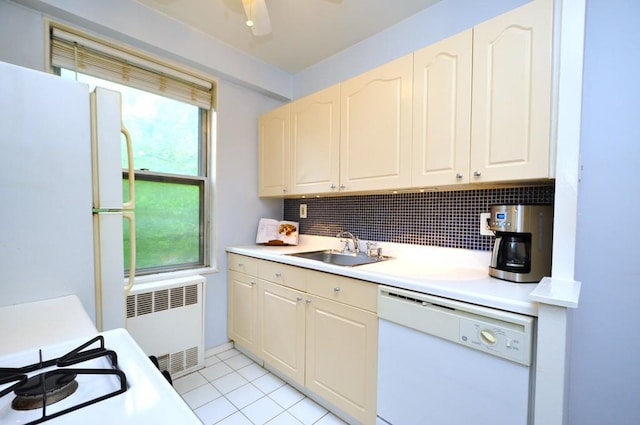 kitchen featuring white appliances, radiator, a sink, decorative backsplash, and light countertops